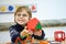 Little kid boy building geometric figures with plastic blocks