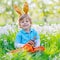 Little kid boy with Easter bunny ears and cupcake