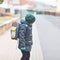 Little kid boy with eye glasses walking from the school. Child on a street. Preschooler wearing warm spring, autumn or