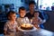 Little kid boy and family, father, brother and baby sister celebrating birthday