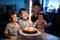 Little kid boy and family, father, brother and baby sister celebrating birthday
