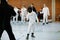 Little kid boy fencing on a fence competition. Child in white fencer uniform with mask and sabre. Active kid training