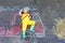 Little kid boy in fireman uniform having fun with fire truck picture drawing with colorful chalk on asphalt. From above