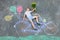 Little kid boy having fun with bicycle chalks picture on ground