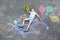 Little kid boy having fun with bicycle chalks picture on ground