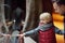 Little kid boy with his father watching animals through the glass in zoo