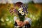 Little kid boy holding bouquet of fields flowers. Child giving flowers