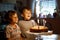 Little kid boys twins celebrating birthday and blowing candles on cake