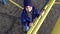 Little kid climbing up on ladder in playground