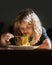 Little kid eating spaghetti in kitchen. Cute child eats food itself with spoon. Little kid are eating, closeup kids face