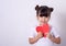 Little kid girl holding a red paper heart, mothers day and love concept