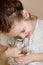 Little kid girl pets a cute gray kitten