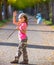 Little kid with hobo stick bag and bundle girl saying goodbye