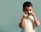 Little kid joking with a fake paper moustache. Happy child playing in home.  background. Movember concept