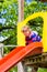 Little Kid on a jungle gym slide