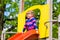 Little Kid on a jungle gym slide