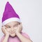 A little kid making funny annoyed face. Annoyed Christmas Boy in Santa Hat