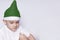 A little kid making a funny annoyed face. Annoyed Christmas Boy in Santa Hat. A really serious and handsome kid