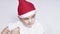 A little kid making a funny annoyed face. Annoyed Christmas Boy in Santa Hat. A really serious and handsome kid