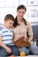 Little kid with mum caressing rabbit pet