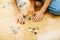 Little kid playing with puzzles on wooden floor together with parent, lifestyle people concept, loving hands to each
