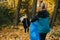 Little kid siblings collecting trash together in a seasonal forest at autumn