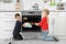 Little kids baking buns in oven