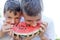 Little kids eating watermelon outdoor