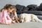 little kids feeding golden retriever dog with treats