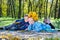 Little kids lying close together in an autumn park