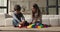 Little kids play colorful plastic blocks at home