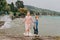 Little kids playing by the lake on a very windy day under summer rain