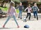 Little kids playing street football outdoors