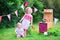 Little kids playing with toy kitchen in the garden