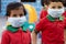 Little kids at school with medical face mask looking at camera - concept School reopen or back to school after covid-19 or coronav