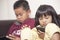 Little kids sister and brother siblings plays on gadget smart phone