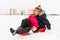Little kids sliding on sled down hill in winter
