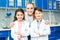 Little kids with teacher in school laboratory team