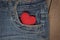 Little knit heart in the front pocket of blue jeans