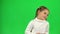 Little lady dancing on green screen in studio