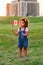 Little latin hispanic baby toddler girl holding waving Canadian flag.