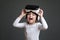 Little laughing girl with virtual reality headset. Innovative technology and education concept