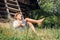 Little lazy boy sleeps under old hayloft in garden