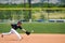 Little league boy reach out to catch ball