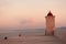 Little lighthouse in the beautiful harbor of a small town Postira Croatia, Brac island.