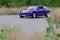 The little Lilac car enters the corner. The Smart Roadster is a