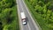 Little lorry driving on the highway, aerial. Green grass and trees on both sides of the road