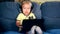 Little lovely child with big headphones watching cartoons on tablet computer