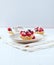 Little mascarpone tart with fresh raspberries on wooden background.