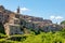 Little medieval town skyline of Grotte di Castro, Lazio, Italy, with blue sky in background
